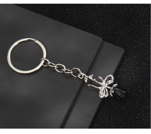 Detailed close-up of a silver alloy keychain featuring a black 3D rose and metal chain