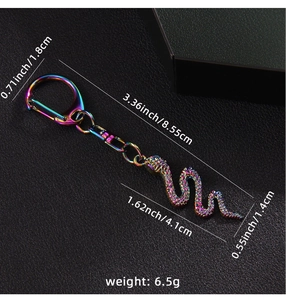 Detailed macro view showing iridescent rainbow plating and scale texture of the snake keychain
