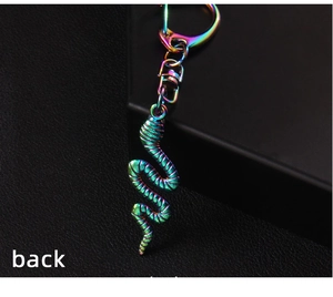 Detail view of the back of a rainbow cobra keychain with intricate scale textures