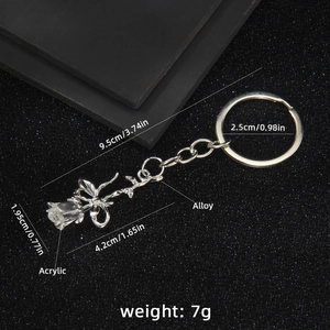 Elegant acrylic rose keychain with silver alloy chain on a textured black background