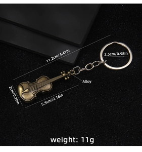 Detail of vintage bronze violin keychain with dimensions and alloy material specifications