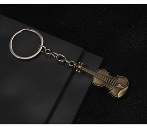 Macro detail of bronze violin keychain with realistic musical instrument texture