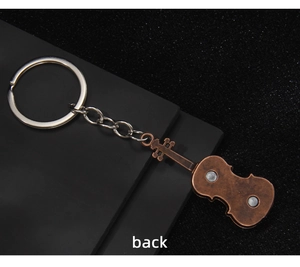 Macro view of vintage bronze violin keychain back side with magnetic insert