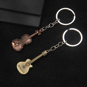 Vintage bronze musical instrument keychains featuring violin and guitar with music engraving