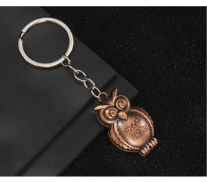 Detailed view of vintage bronze owl keychain featuring Good lucky engraving on its belly