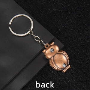 Vintage bronze owl keychain with brushed metal texture and silver ring back view