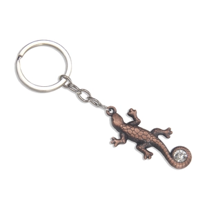 Porte-clés lézard en bronze avec texture écaillée et cristal brillant sur fond blanc