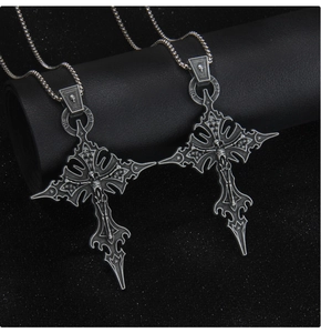 Macro shot of gothic punk cross pendant with skull details and vintage steel finish