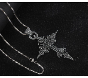 Macro shot of gothic stainless steel cross necklace with LAST ONE engraved detail