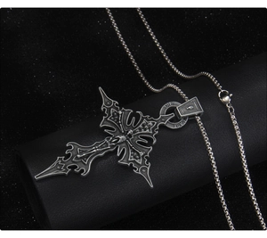 Detail of gothic stainless steel cross necklace featuring a skeleton design on black leather