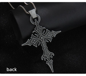 Macro shot of the gothic cross pendant with rune engraving and weathered silver texture
