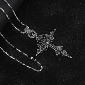 Gothic punk stainless steel cross pendant necklace with skull details on black surface