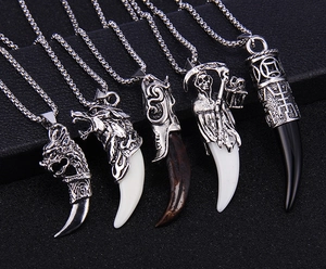 Detailed group view of assorted gothic wolf tooth pendants with vintage metal carvings