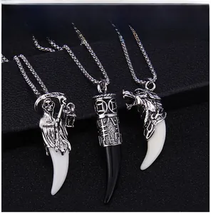 Detailed view of three wolf tooth pendants with grim reaper and dragon metal motifs