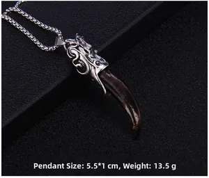 Detailed macro view of retro dragon head pendant with dark brown tusk-shaped charm