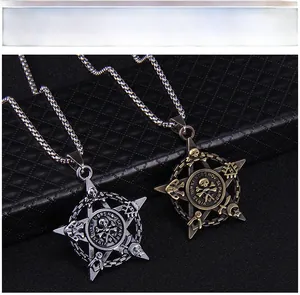 Detail of retro punk pirate skull and pentagram pendants in silver and bronze finishes