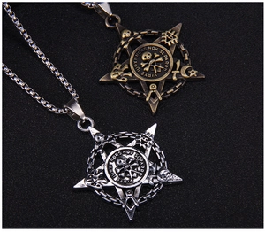 Close-up of gothic pentagram skull pendants in antique bronze and silver finishes