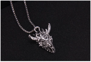 Macro detail of gothic bull skull pendant with hexagram engraving and box chain link