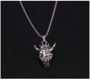 Macro shot of punk style goat skull necklace with silver finish and hexagram detail
