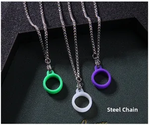 Detail view of steel box chain necklace with three silicone pendant rings in multiple colors