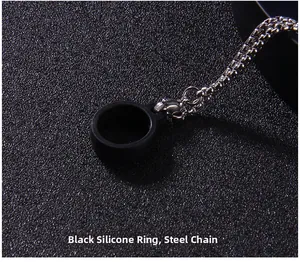 Close-up of black silicone ring connector and polished stainless steel chain link detail