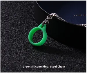 Close-up of a green silicone ring attached to a steel chain with a lobster clasp