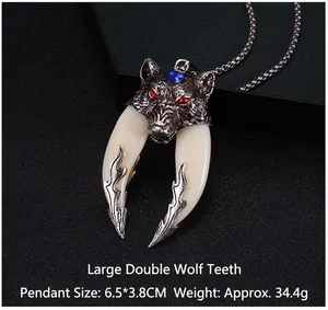 Detailed close-up of a dual wolf fang pendant necklace with red gemstone eyes and blue stone