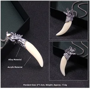 Detailed view of dragon head pendant with faux fang and acrylic inlay on metal chain