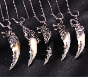 Detailed macro view of retro animal totem pendants with silver finish and horn shape charms