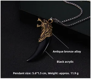 Detailed view of the wolf head pendant with black acrylic fang and bronze metal carving
