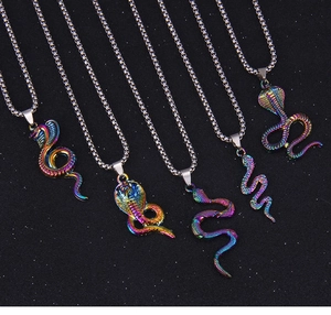 Macro detail of rainbow plated snake pendants on punk style silver metal chains