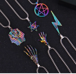 Macro shot of colorful stainless steel pendants featuring mystic eye and pharaoh designs