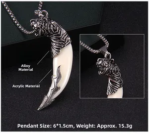 Detail of vintage wolf tooth pendant with dragon head design and stainless steel bead chain