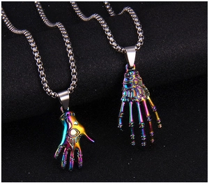Macro shot of punk gothic hand-shaped pendants with rainbow plating and evil eye detail