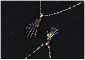 Macro detail of gothic iridescent skeletal hand and mystic eye charms on steel chains