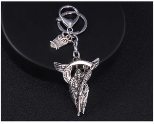 Detailed silver Grim Reaper and owl charms on a punk style metal keychain pendant