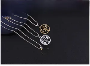 Detailed view of three vintage Tree of Life pendants in gold and silver finishes