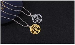 Detail of gold and silver hollow Tree of Life pendants on stainless steel box chains