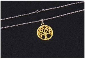 Detail view of a gold-toned hollow Tree of Life pendant with a silver steel box chain