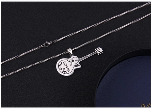 Macro shot of silver guitar necklace featuring Love engraving and fine scroll details