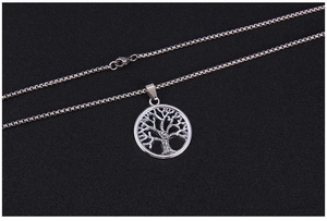 Close-up of silver tree of life pendant with intricate cutout on sturdy box chain