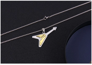 Detail view of a dual-tone stainless steel electric guitar pendant on a long box chain
