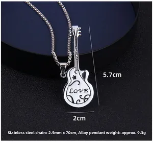 Macro detail of guitar pendant with LOVE engraving and stainless steel chain necklace