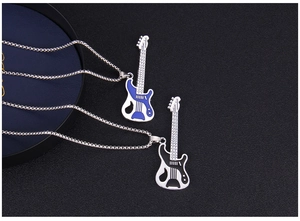 Detailed close-up of guitar pendants with blue and black enamel finish on long chains
