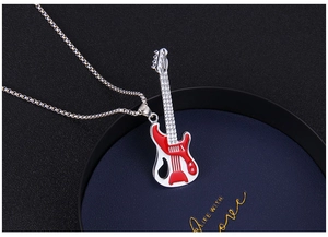 Detail of guitar pendant with red and white enamel on a polished silver chain