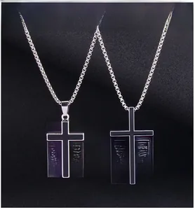 Detail showing vintage black enamel cross pendants on stainless steel chains in two sizes