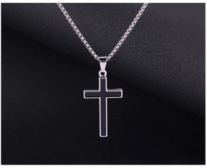 Detail of vintage silver cross pendant with black enamel inlay on a box chain