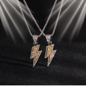 Detailed view of hip-hop lightning bolt pendants with full zircon stones and silver box chain