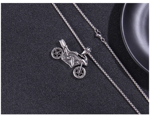 Macro detail of vintage punk style stainless steel motorcycle pendant with aged texture