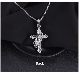 Reverse side view of stainless steel cross pendant with detailed prayer hand engraving